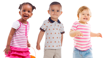 Three toddler-aged children of different races walking and smiling.