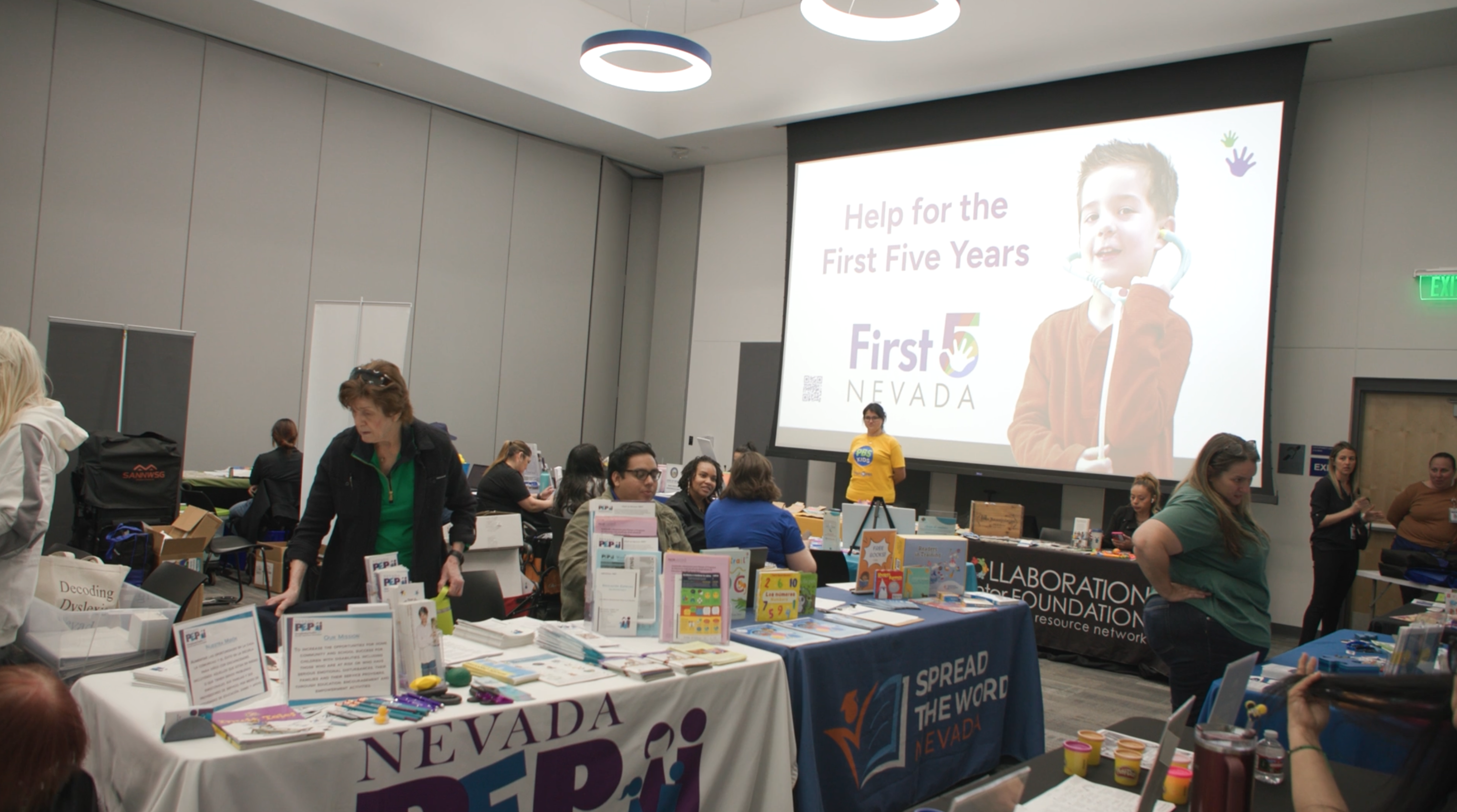 April 2025 Screening event. Room filled with sponsors for event and people sitting at tables. 